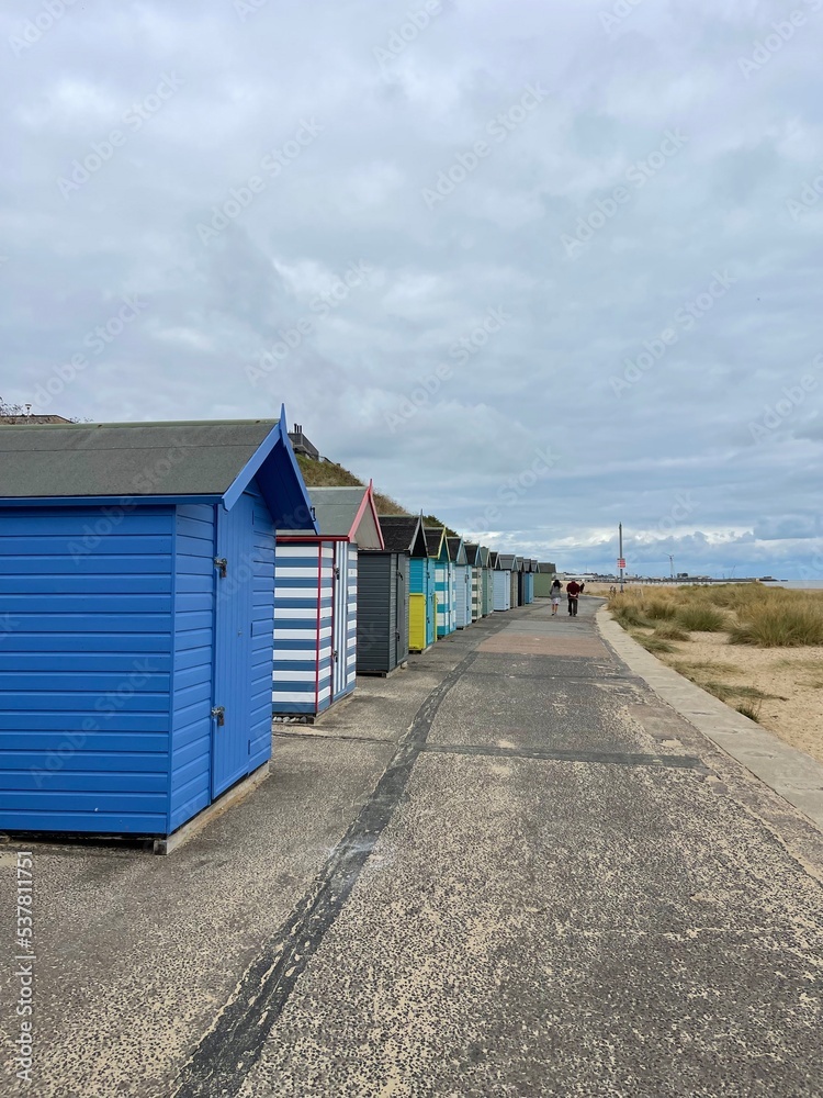 Beach huts on the seafront painted bright colours. Taken in Lowestoft England. Beach huts on the seafront painted bright colours. Taken in Lowestoft England.