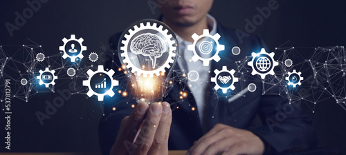 Billede på lærred businessman holding a light bulb for a new idea brainstorm inspiration Smart Business Ideas and a global network of inspirational innovative ideas
