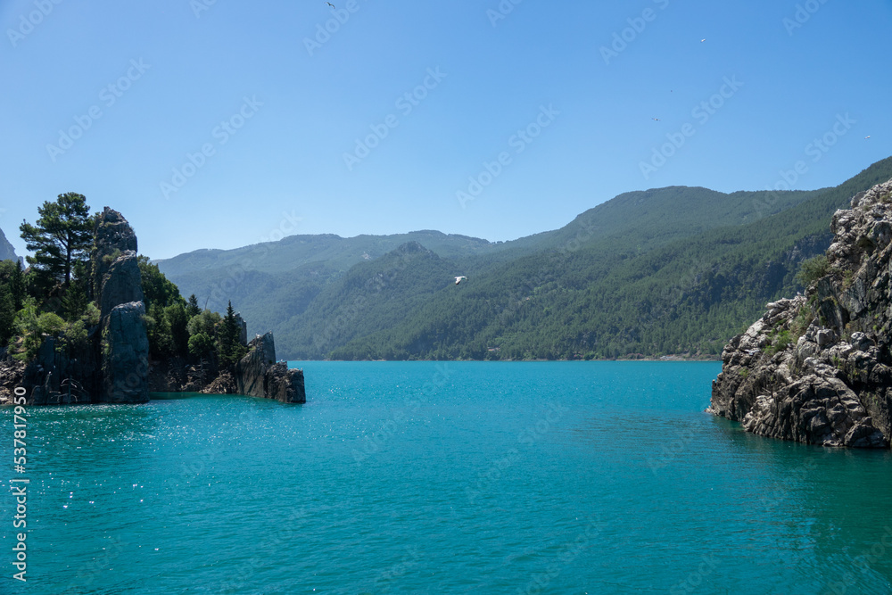 View of the lake with clear turquoise water and on the mountain cliffs of the Green Canyon. Manavgat, Antalya, Turkey