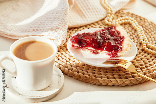 Vintage aesthetic coffee time with cherry pie and cup of coffee, pearlcore under hard shadows. Cozy home atmosphere photo