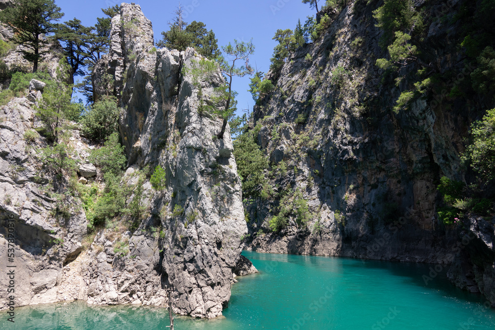 View of the lake with clear turquoise water and on the mountain cliffs of the Green Canyon. Landscape of Green canyon, Manavgat, Antalya, Turkey