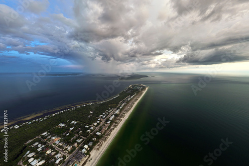 Fotografi View from above of large storm approaching over residential houses in island small town Boca Grande on Gasparilla Island in southwest Florida