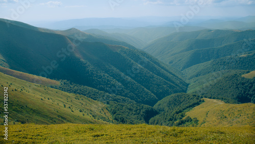 View on beautiful hills valley between mountains. Aesthetic landscape of clear nature  fresh foggy weather. Amazing view from high rock