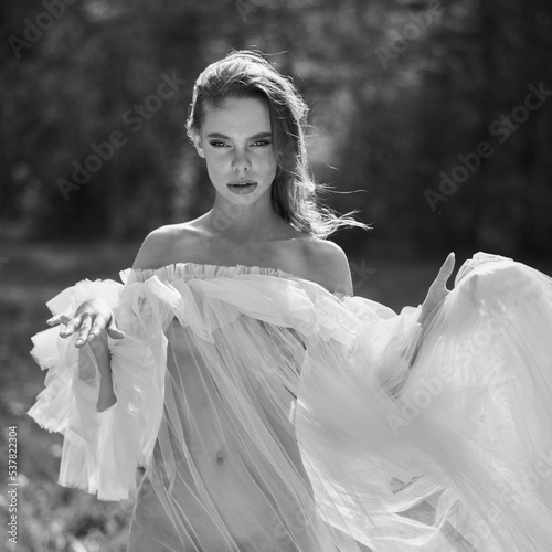 Sexy blonde in dress posing in nature. Art portrait of nude woma
