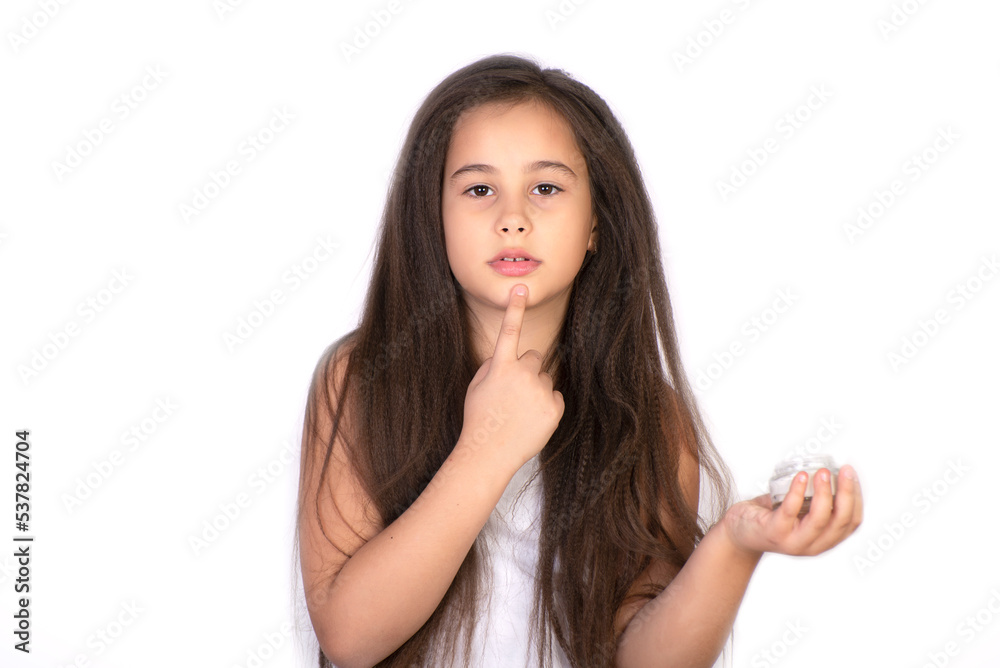 Fototapeta premium Happy child presenting beauty cosmetic product of facial skin cream