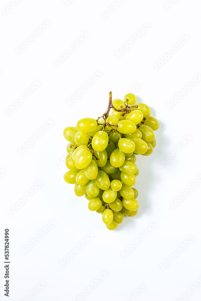 A branch of juicy and delicious grapes on a white background view from above