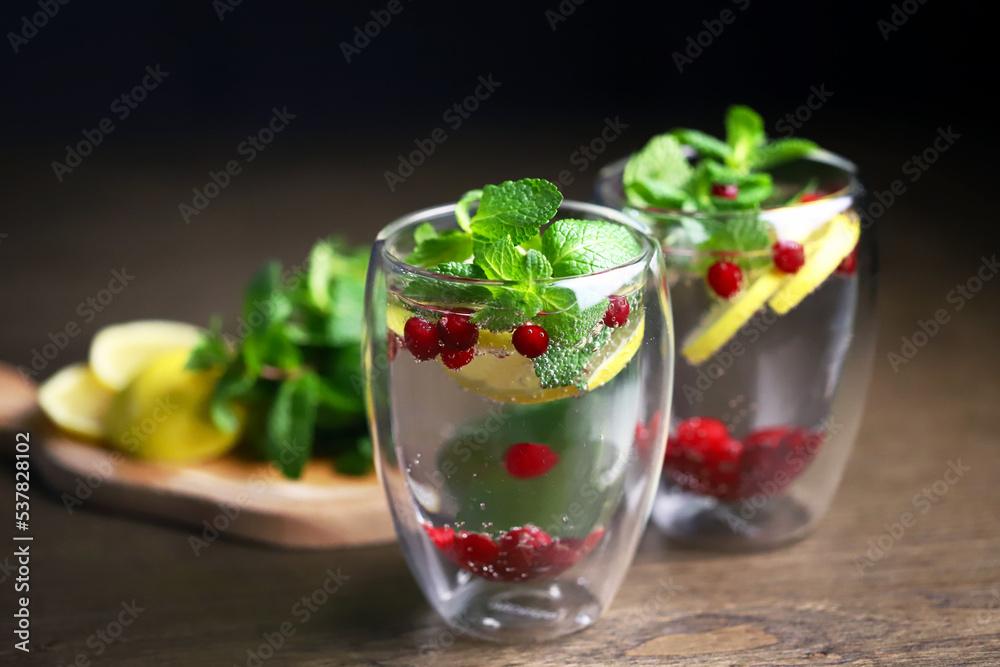 Soft focus. Macro. Detox drink with cranberries, mint and lemon in a glass on a dark background. Healthy beverage. Soft focus. Macro. Detox drink with cranberries, mint and lemon in a glass on a dark background. Healthy beverage.