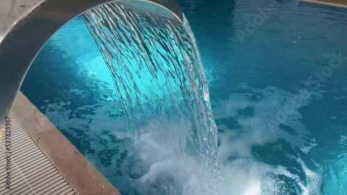 Empty Swimming pool with waterfall jet and jacuzzi in action