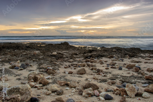 Photo of the beauty of pebbles and rocks on Lampuuk beach at sunset in the afternoon