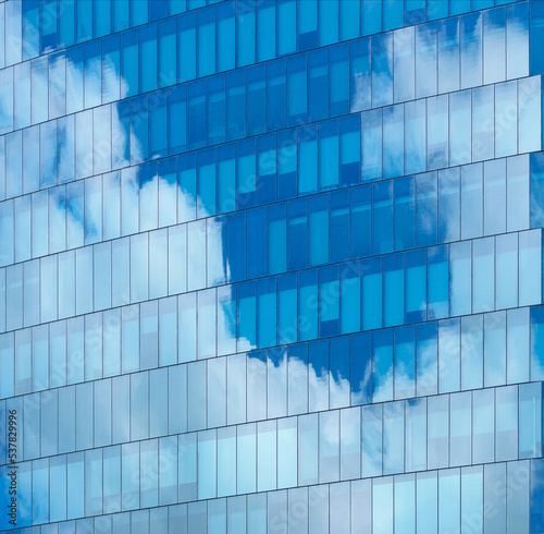 soft light glass wall exterior architecture building reflection cloud and blue sky clean environment background.for modern business office,ecology,smart city design.