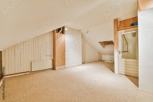 A cozy and spacious mansard empty room in a luxury house