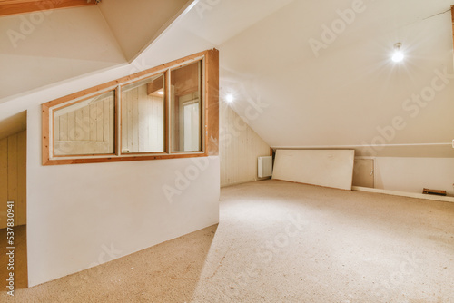 Tableau sur toile A cozy and spacious mansard empty room in a luxury house