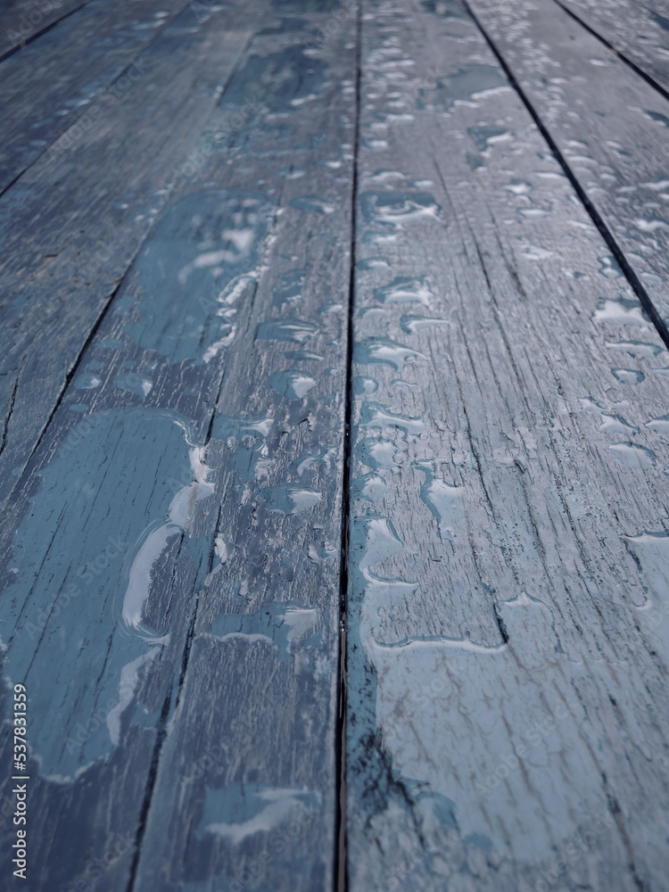 Water spread over old wooden planks painted with gray paint vertical photo for background or wallpaper
