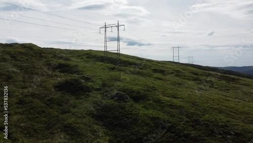 Power lines on the green slope. Arna, Norway. photo