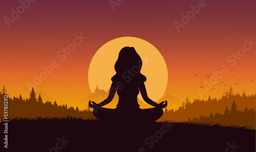 silhouette of a woman meditating in the sunset