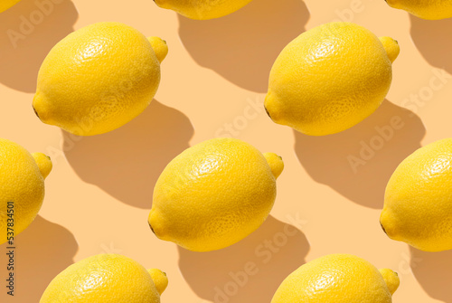 Foto Pattern from lemon fruit on yellow pastel soft color background