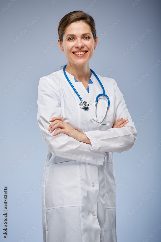Smiling doctor woman in white coat standing with arms crossed. Isolated portrait. Smiling doctor woman in white coat standing with arms crossed. Isolated portrait.