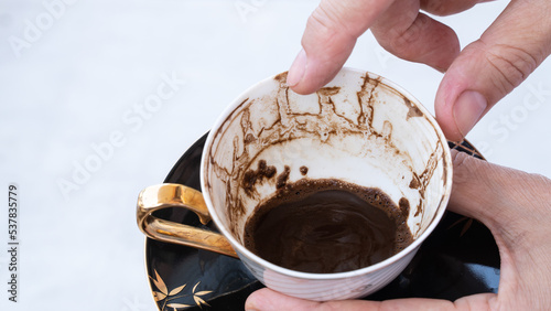 Fortune telling with coffee. Woman fortune teller predicting the future with coffee grounds photo