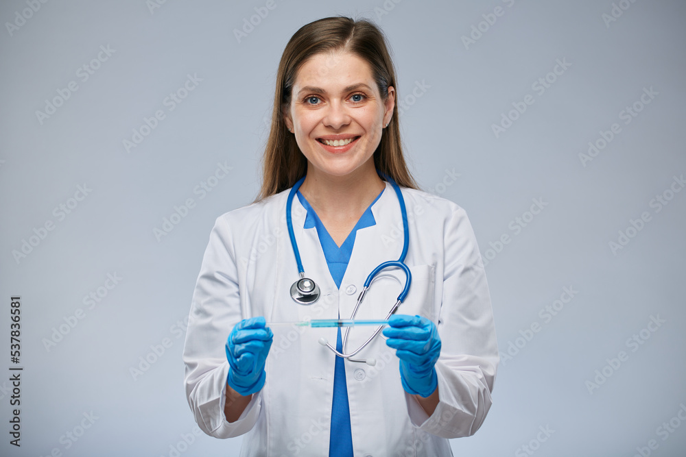 Doctor in blue gloves holding syringe with vaccine. Isolated portrait. Doctor in blue gloves holding syringe with vaccine. Isolated portrait.