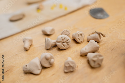 Close up view of clay souvenirs on table in pottery workshop.