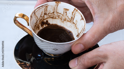 Fortune telling with coffee. Woman fortune teller predicting the future with coffee grounds photo