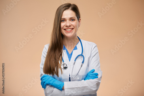 Smiling woman doctor with arms crossed. Isolated portrait.