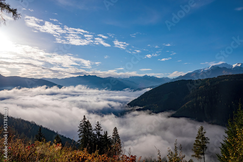 beautiful sunrise on the mountains with view of the alps and a misty valley at autumn morning