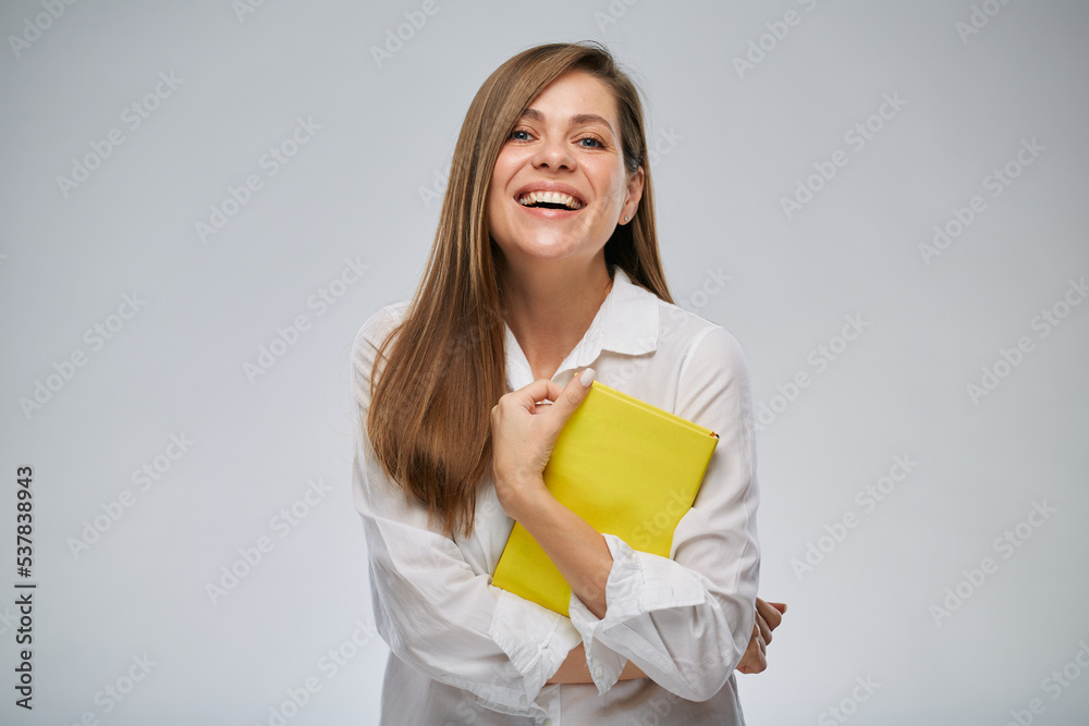 Smiling teacher woman holding yellow book, isolated female portrait. Smiling teacher woman holding yellow book, isolated female portrait.