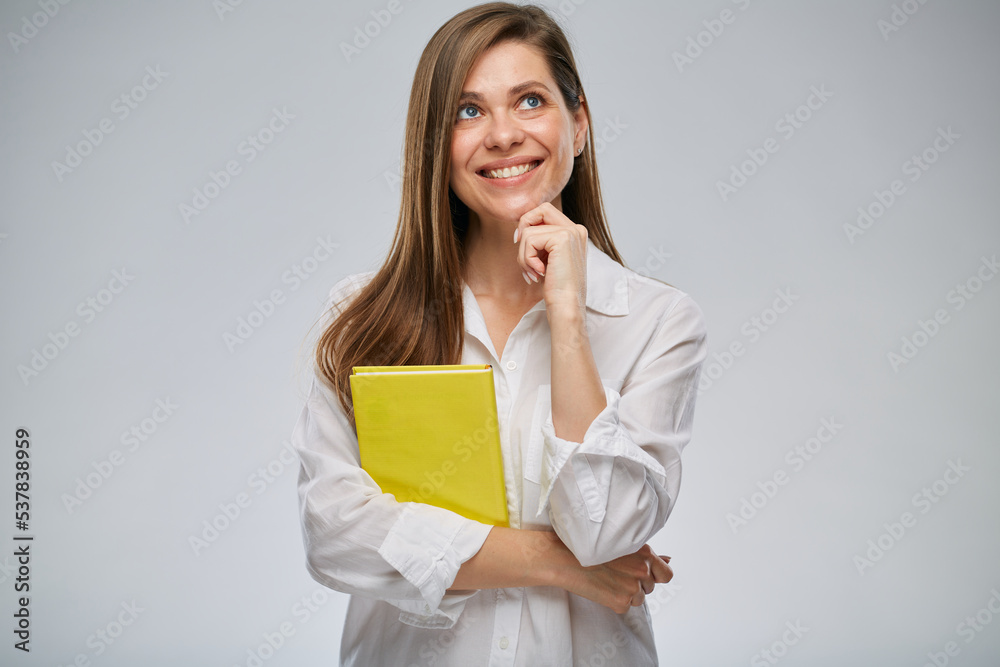 Student or teacher woman looking up holding yellow book, isolated female portrait. Student or teacher woman looking up holding yellow book, isolated female portrait.