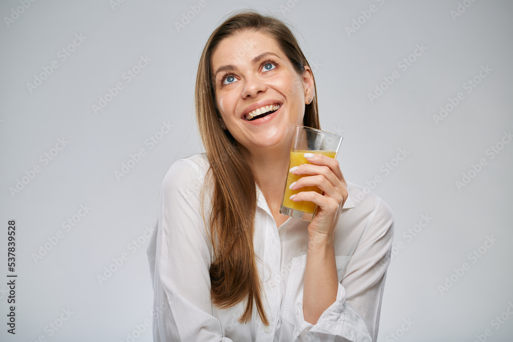 Smiling woman looking up holding orange juice. Isolated female advertising portrait. Smiling woman looking up holding orange juice. Isolated female advertising portrait.