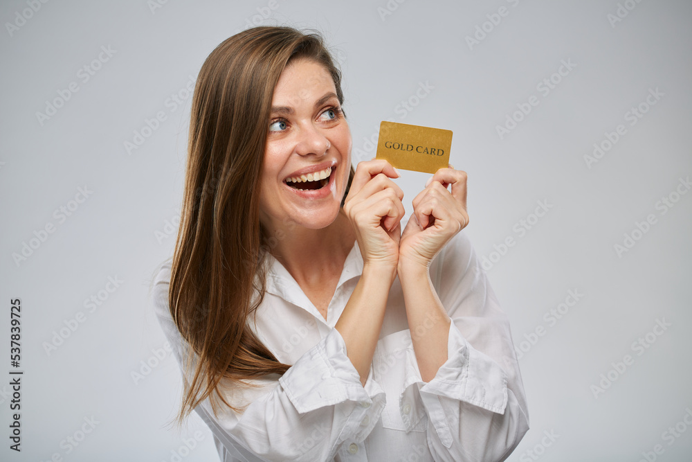 Happy excited woman in white shirt holding credit card. Isolated advertising female portrait on white. Happy excited woman in white shirt holding credit card. Isolated advertising female portrait on white.