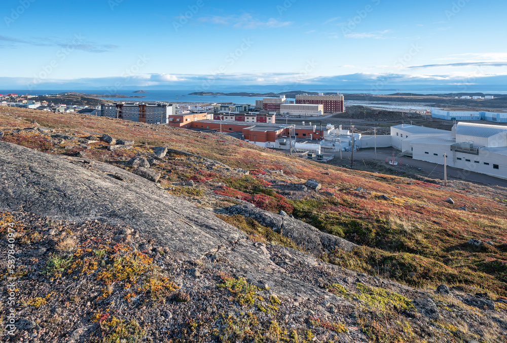 Overview of the city of Iqaluit with the Arctic Ocean harbor in the distance