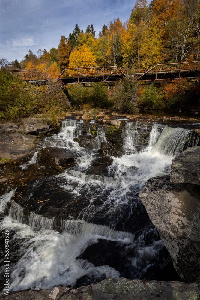 Tanners Falls in the Poconos near Honesdale, PA, on a brilliant fall day, which features multiple cascades and a historic bridge 