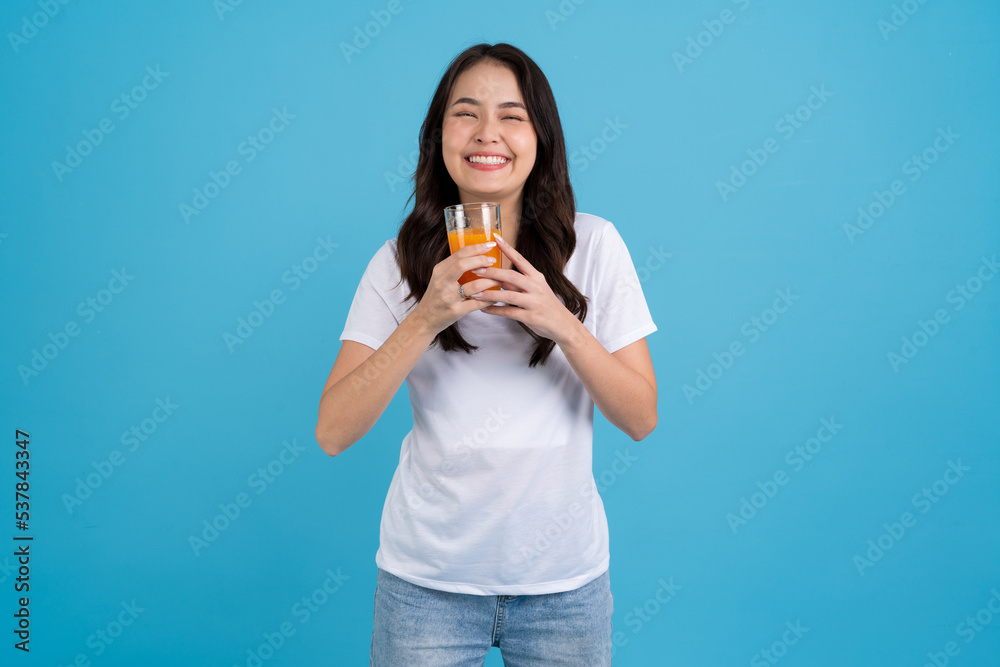 Beautiful woman drinking orange from a glass Beautiful woman drinking orange from a glass
