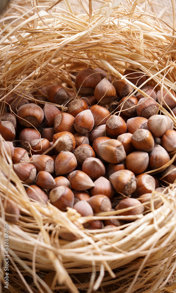 hazelnuts in a basket on a brown background hazelnuts in a basket on a brown background