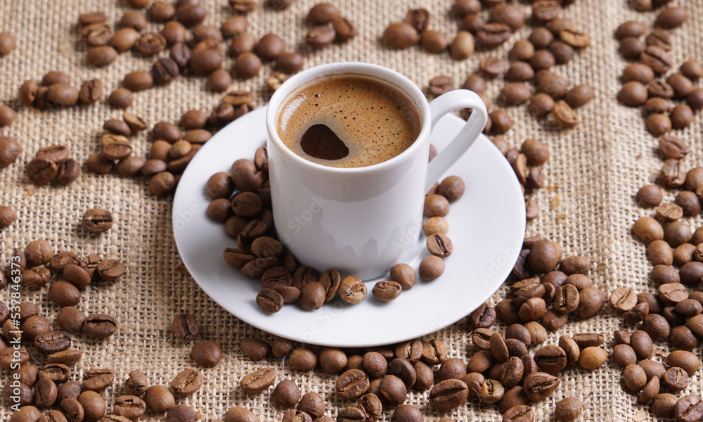 Fototapeta premium Turkish coffee with coffee beans on a brown background