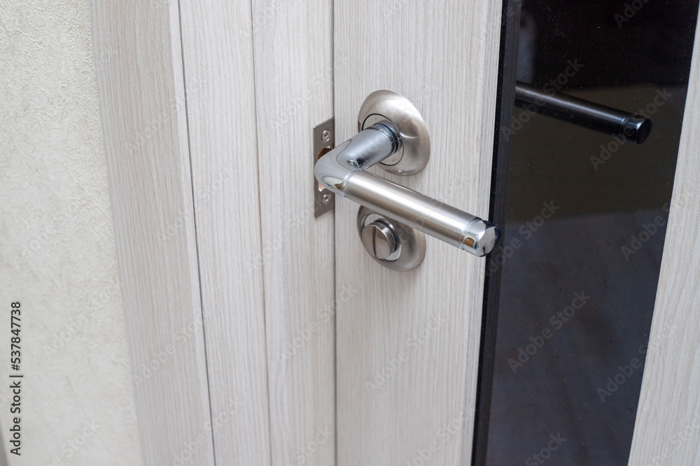 metal handle on the wooden door of the room metal handle on the wooden door of the room