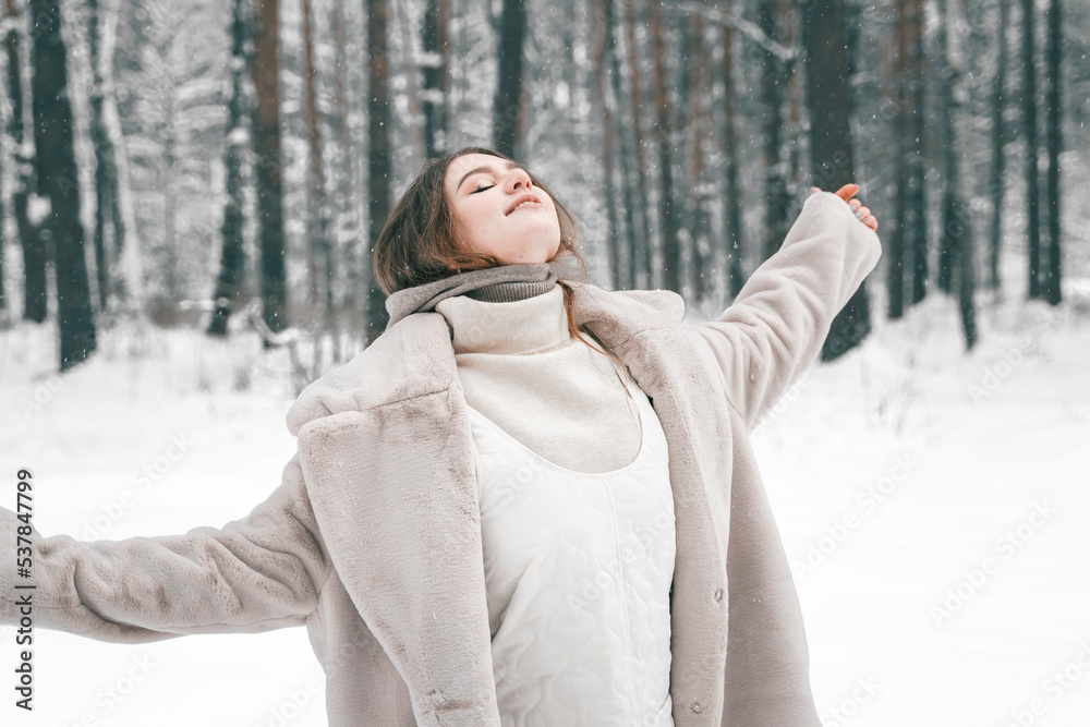 Obraz premium Young beautiful girl in snowy cold winter frost forest. Walking, having fun, laughing in stylish clothes, fur coat, woolen shawl, bonnet. Snow trees lovestory. Romantic date, weekend