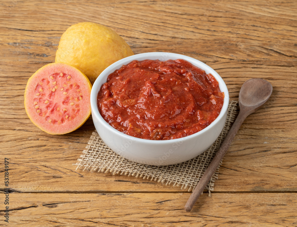 Goiabada, traditional brazilian creamy guava sweet with fruits over wooden table Goiabada, traditional brazilian creamy guava sweet with fruits over wooden table