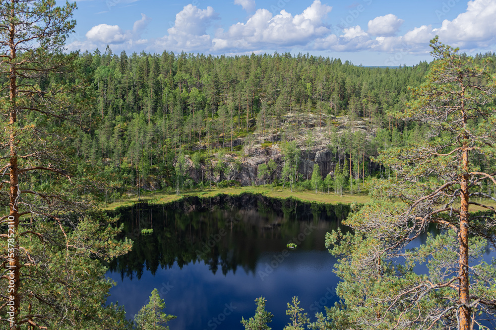 View from Hauklamminvuori Hill to the Hauklampi lake, rocks and forest in the Repovesi National Park on sunny summer day View from Hauklamminvuori Hill to the Hauklampi lake, rocks and forest in the Repovesi National Park on sunny summer day