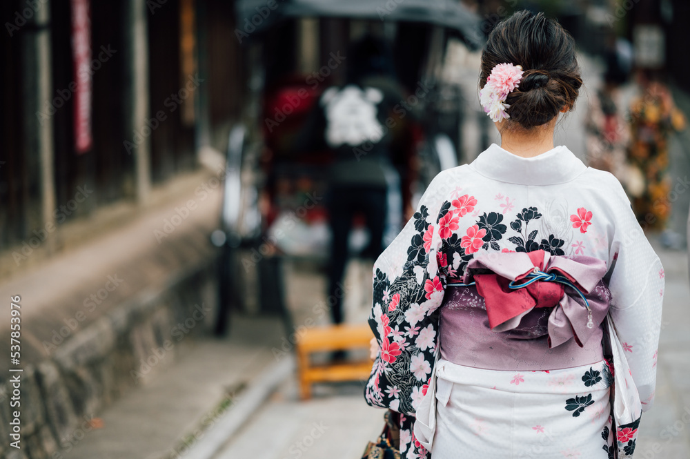 Young women wearing traditional Japanese Kimono with colorful maple trees in autumn is famous in autumn color leaves and cherry blossom in spring, Kyoto, Japan. Young women wearing traditional Japanese Kimono with colorful maple trees in autumn is famous in autumn color leaves and cherry blossom in spring, Kyoto, Japan.