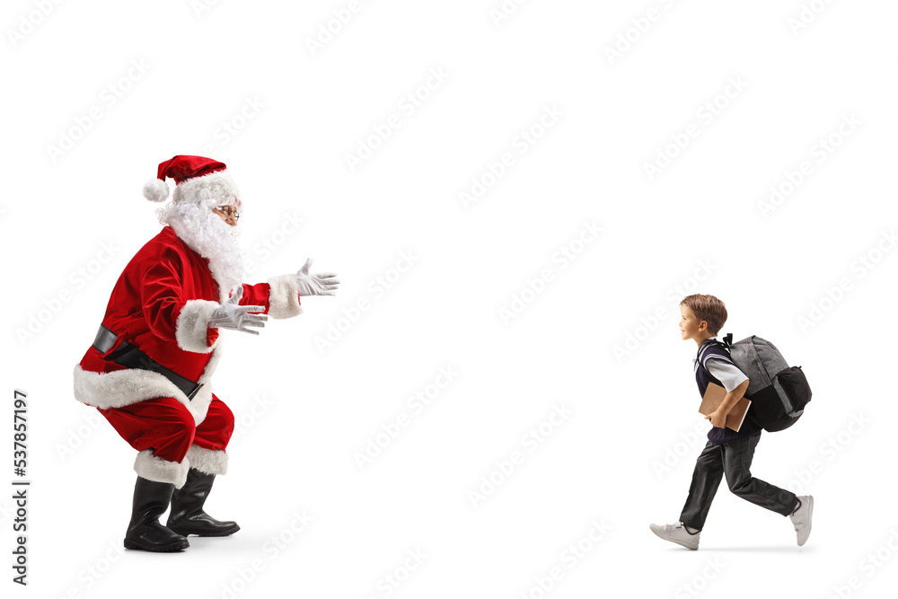 Schoolboy running to hug santa claus Schoolboy running to hug santa claus