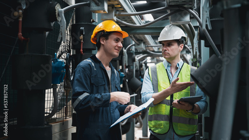 Engineer and team examining the air conditioning cooling system of a huge building or industrial site.