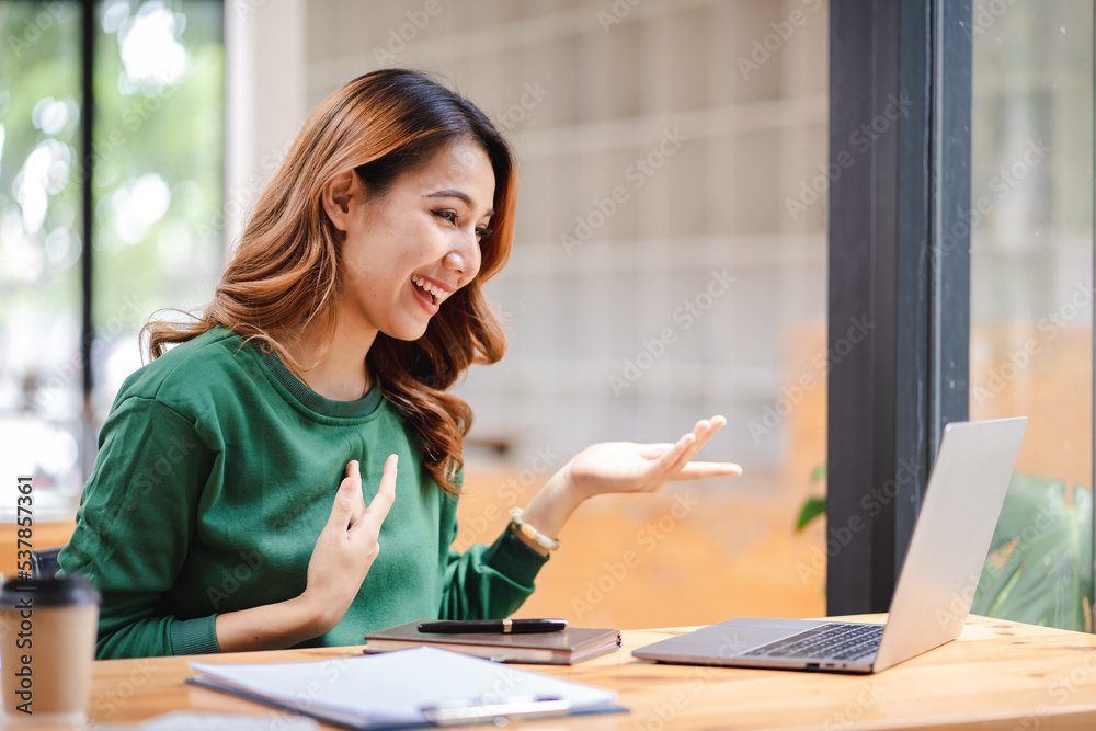 Asian business woman Video call in a teleconference and greet the result..Girl using laptop to video call her friends.