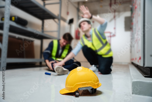 An engineer calls for assistance after a team member sustains a leg injury while doing electrical work.