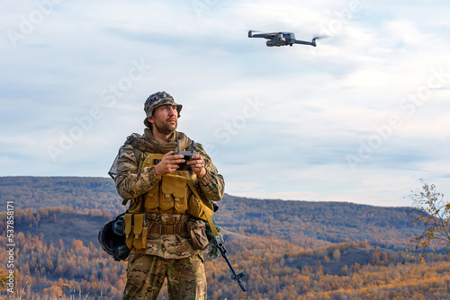Photo of an artillery spotter or military observer launches a drone into the sky for reconnaissance in enemy territory.