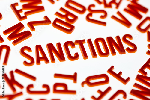 
Sanctions. Letters on a light background. News headline.
