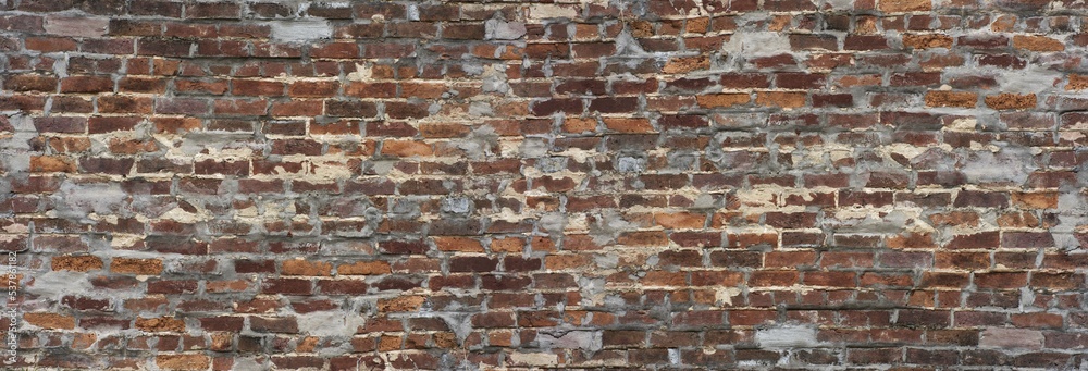 Long old brick wall background with red and orange bricks and holes filled in with concert. Long old brick wall background with red and orange bricks and holes filled in with concert.