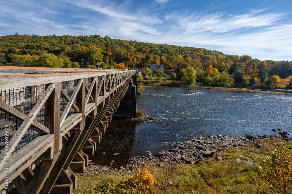 Historic Roebling Bridge also known as Roebling's Delaware Aqueduct over the Delaware River on a brilliant fall morning Historic Roebling Bridge also known as Roebling's Delaware Aqueduct over the Delaware River on a brilliant fall morning