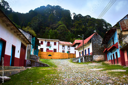 traditional village in middle of the forest in cloudy day, beautiful rustic houses in original town of latin america, the incarnation zimapan hidalgo  photo
